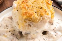 Golden Butter Swim Biscuits Smothered in Savory Sausage Gravy