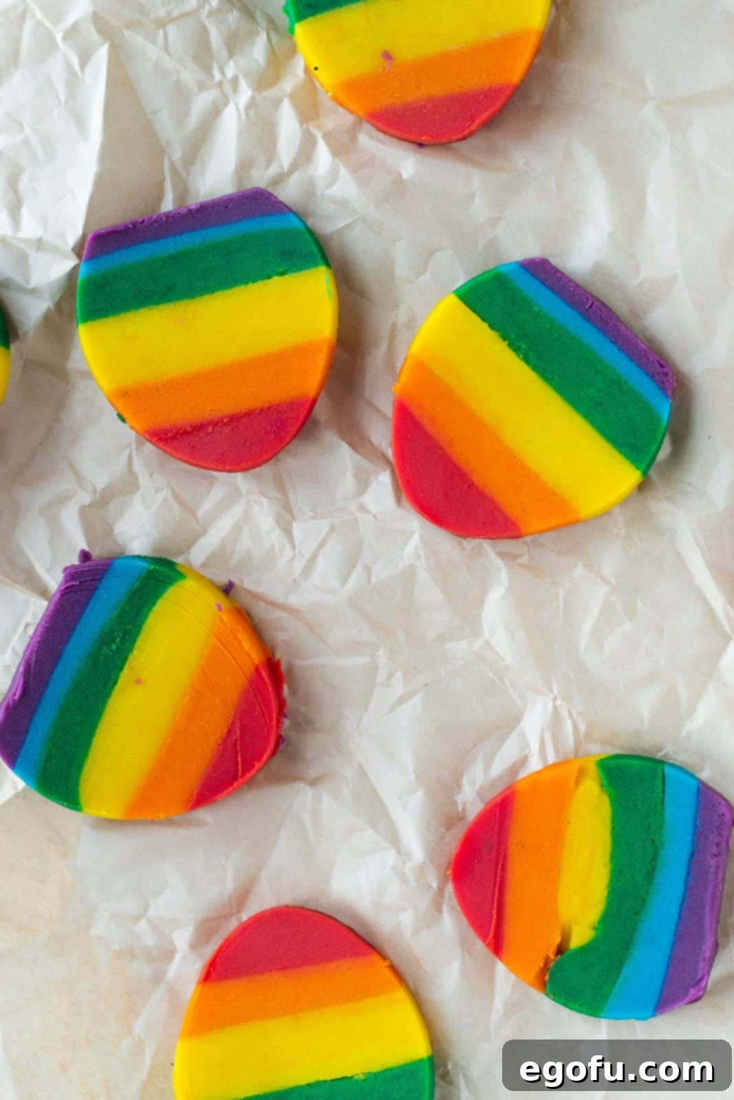 Layered dough with colors on parchment paper.