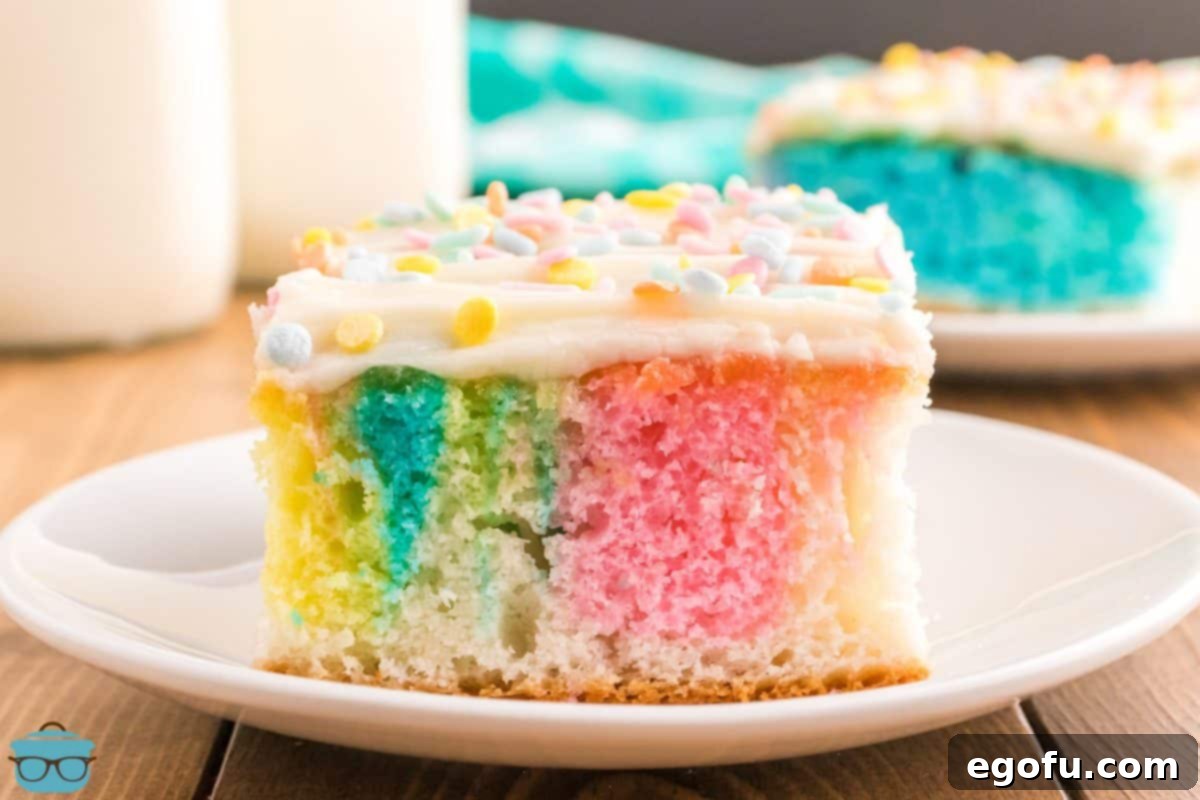 Slice of Swirled Easter Cake on white plate, revealing vibrant colors.