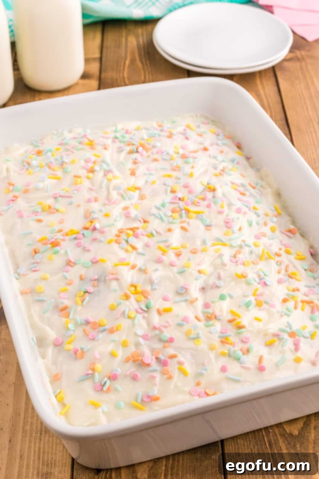 Frosted cake decorated with pastel Easter sprinkles.