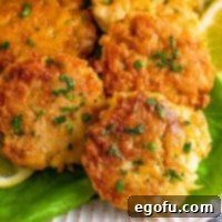 Lowcountry Crab Delights 11 Square image close up of Southern Crab Cakes stacked on lettuce.