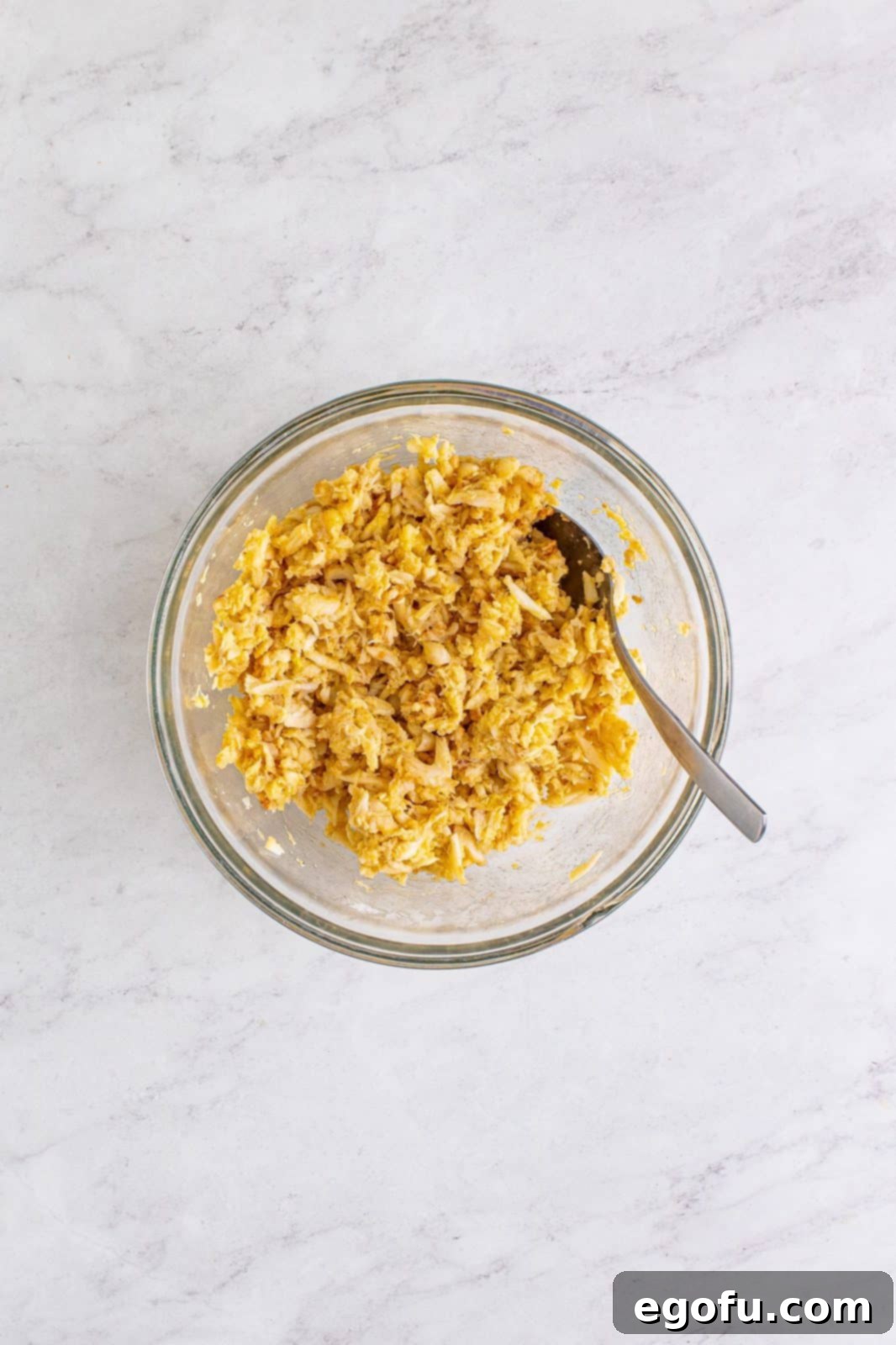 Lowcountry Crab Delights 5 Crab mean, egg, flour, salt, paprika, and black pepper mixed together in bowl.