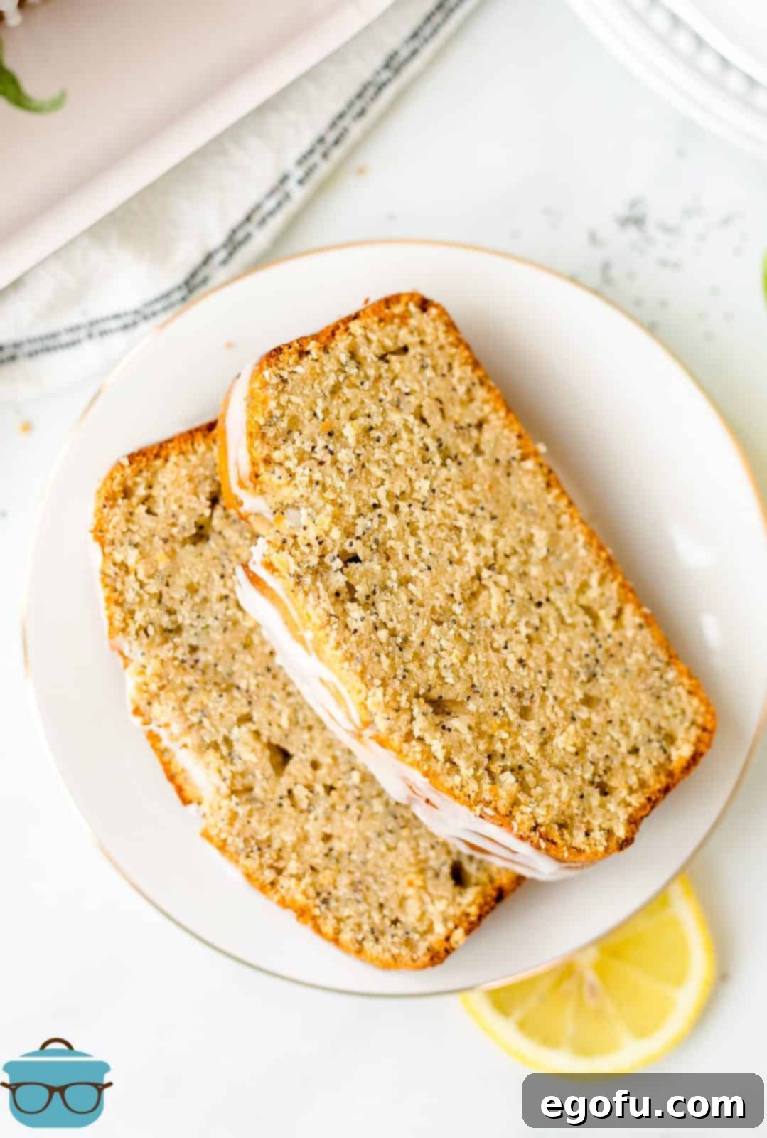 Overhead of two slices of Lemon Poppy Seed Bread on plate.