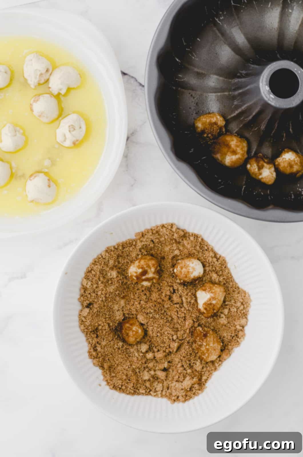 Dough balls being rolled into melted butter and cinnamon sugar mixture.