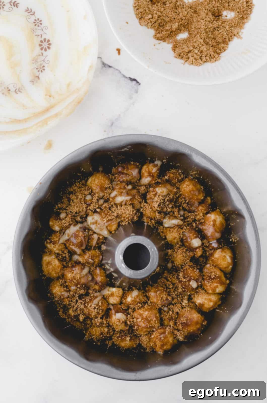 Dough balls placed into bundt pan in layers.