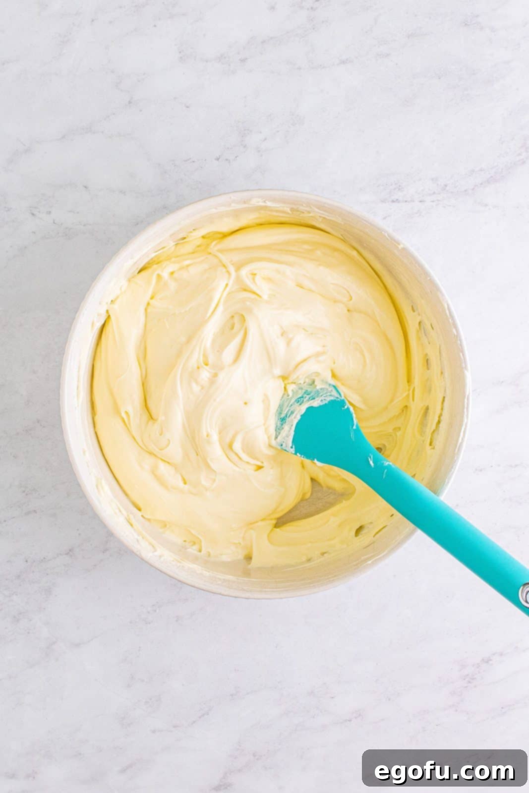 Whipped cream folded into cheesecake mixture.