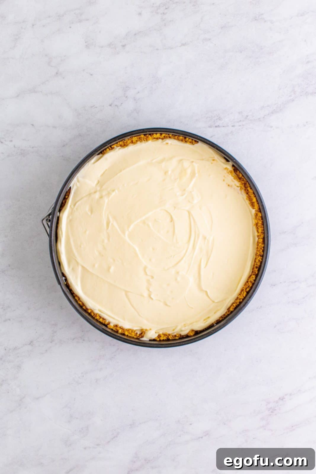 Cheesecake mixture spread into pan with crust.
