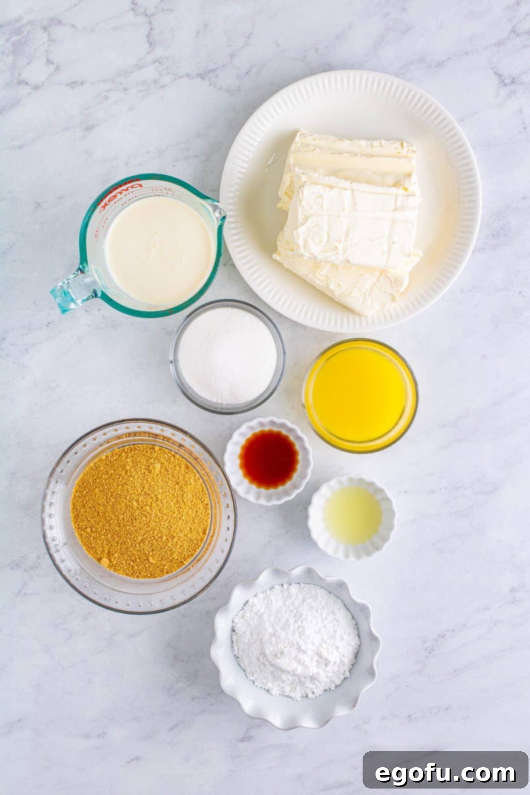 Ingredients needed: graham cracker crumbs, unsalted butter, granulated sugar, cream cheese, powdered sugar, vanilla extract, lemon juice and heavy whipping cream.