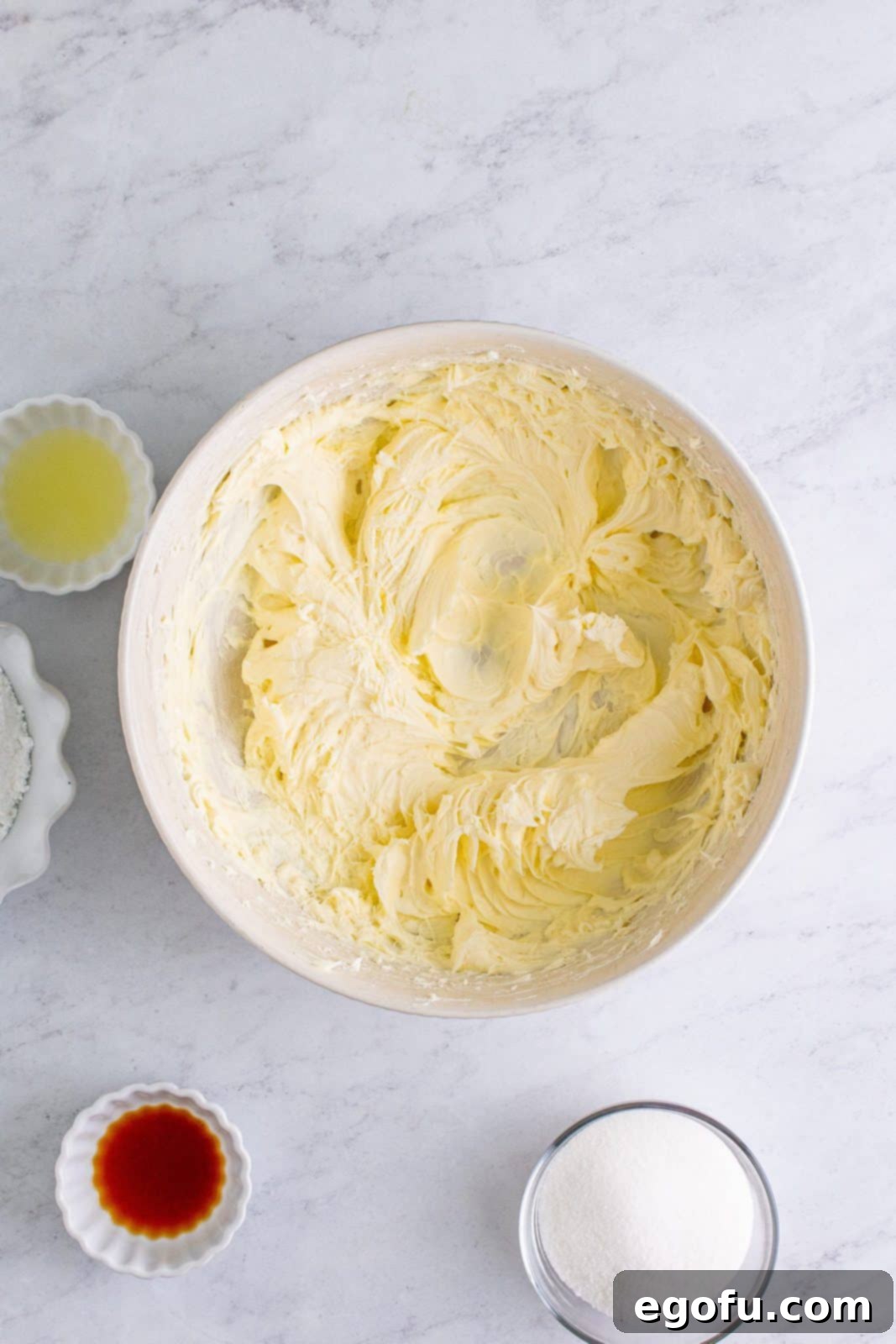 Cream cheese beaten in bowl.