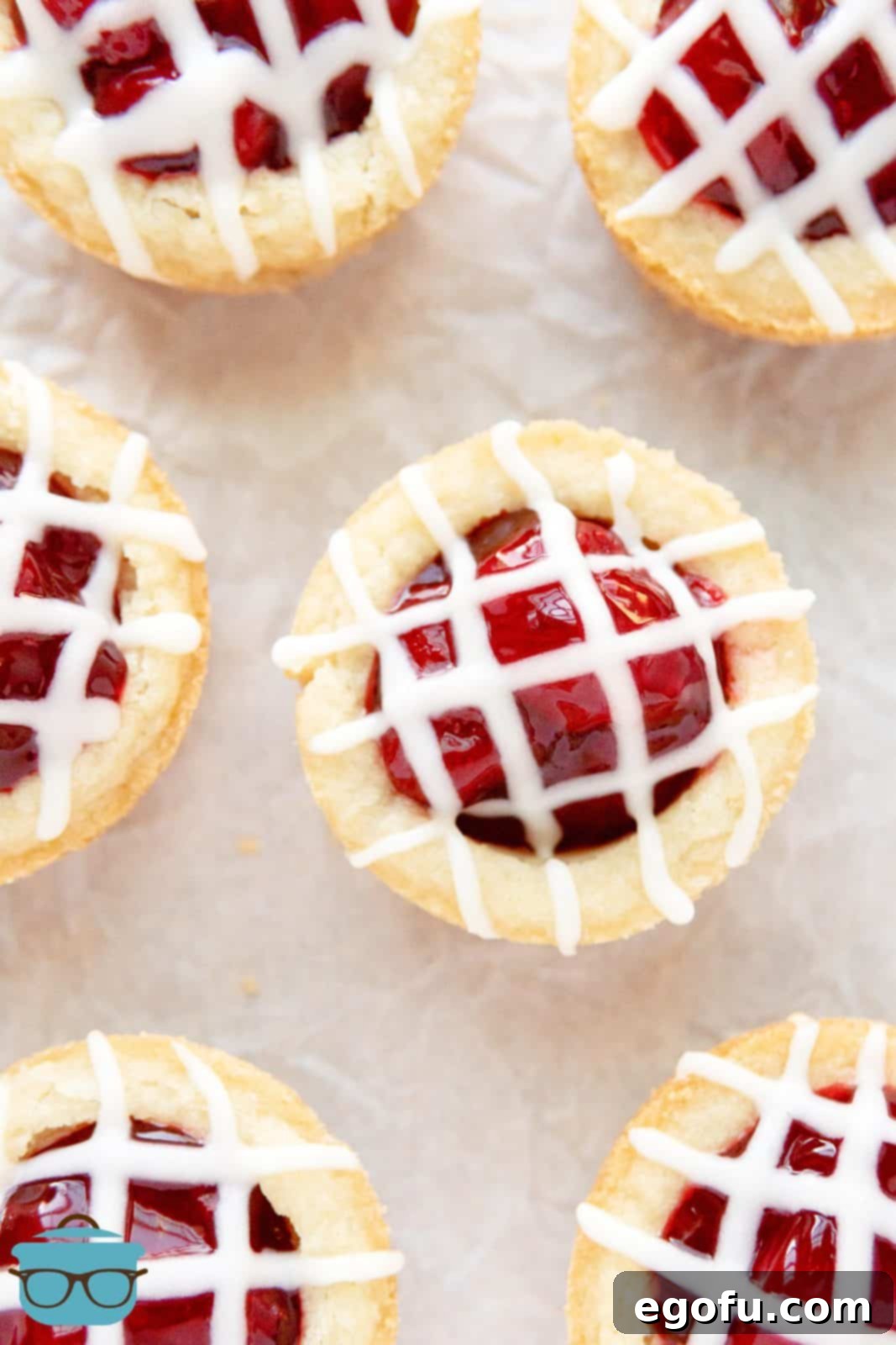 Strawberry Cookie Delights 11 Overhead of glazed Strawberry Cookie Cups on parchment paper.