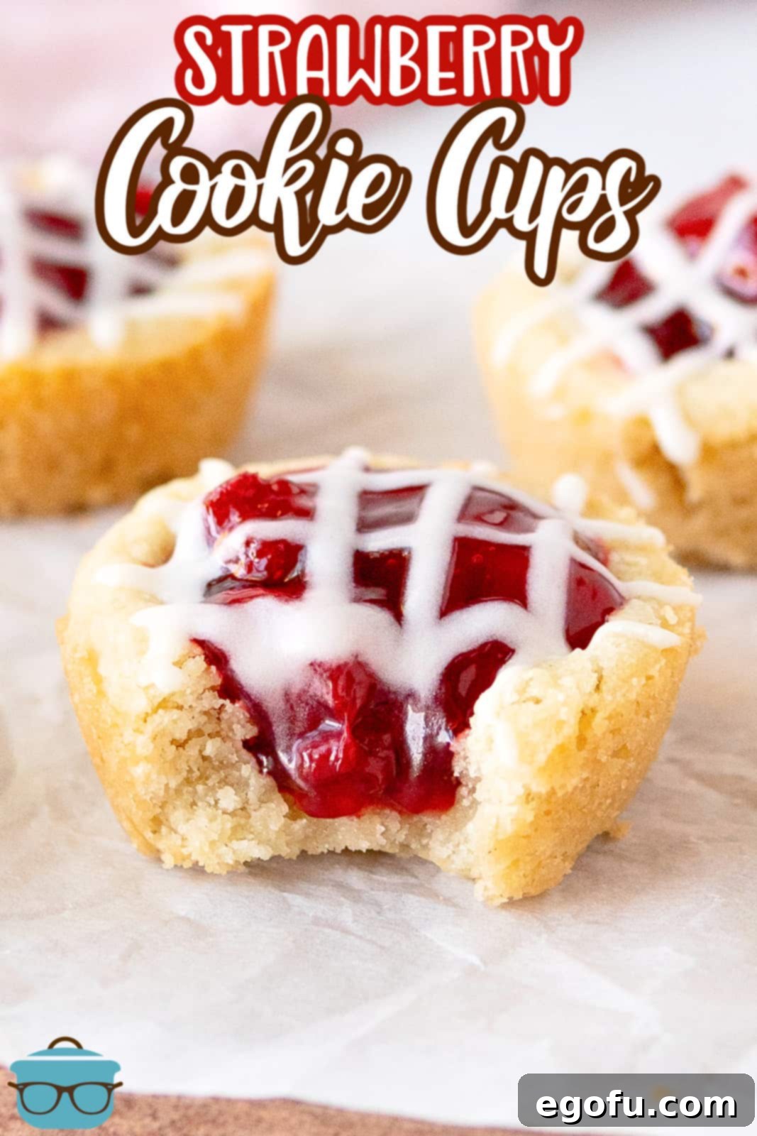 Strawberry Cookie Delights 3 Pinterest image of Strawberry Cookie Cups with front one having a bite out of it.