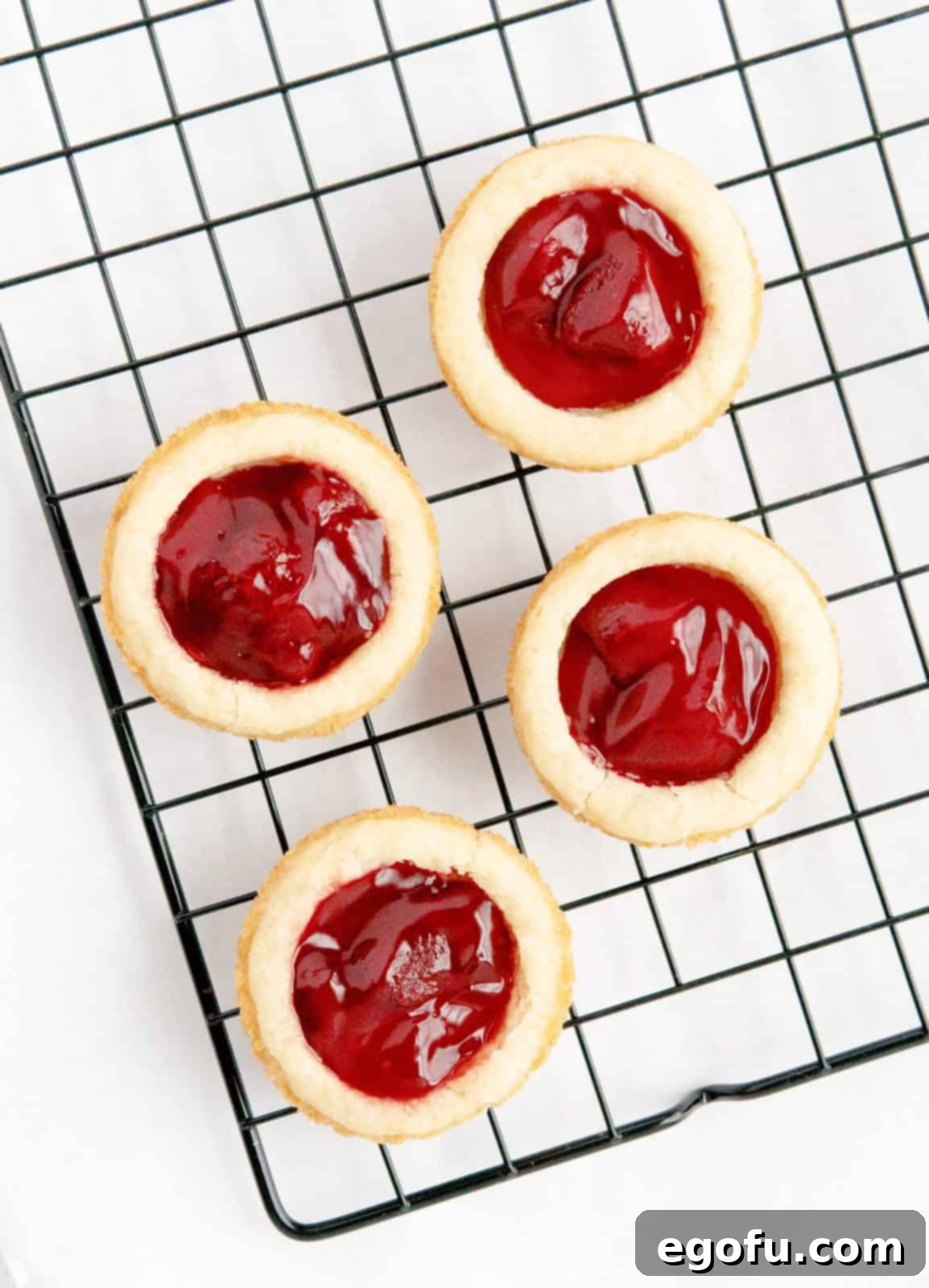 Strawberry Cookie Delights 10 Finished cookie cups on wire rack.