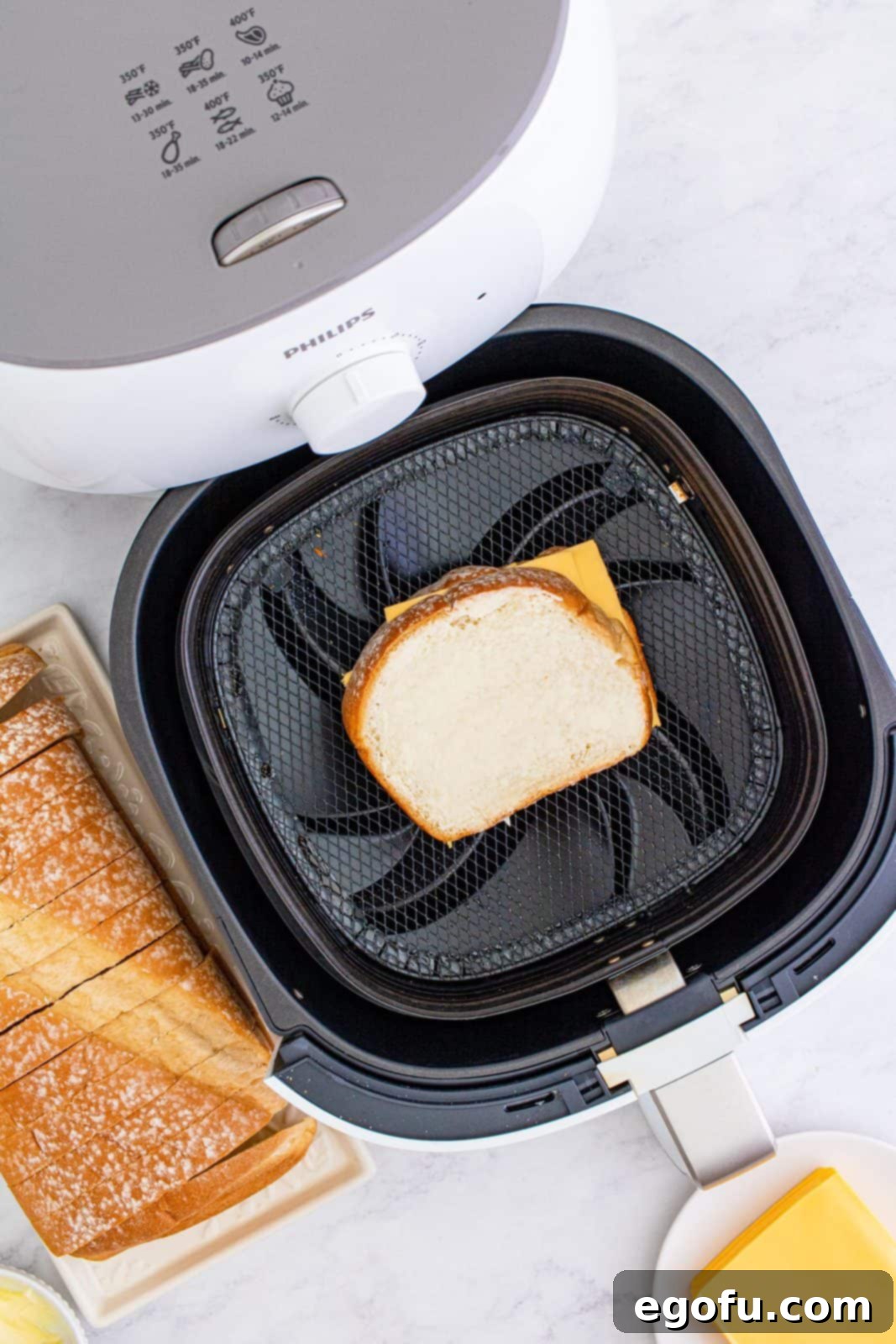 Air Fryer's Golden Crispy Grilled Cheese 8 Another slice of buttered bread placed butter side up over cheese.