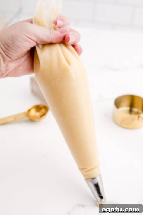 Dough added to a piping bag with piping tip.
