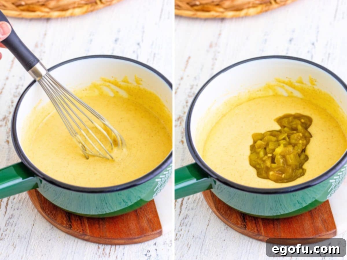 A whisk actively stirring the melting cheese, heavy cream, and spices in a saucepan, creating a smooth, creamy dip.