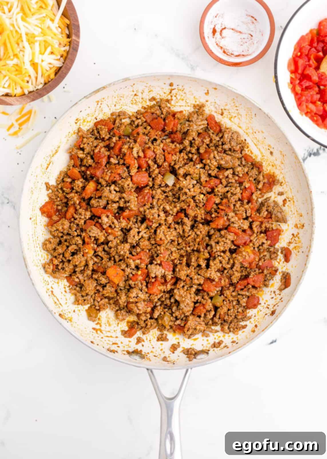 Zesty Taco Roll-Ups 7 The fully combined and simmered taco mixture, glistening and flavorful, ready to be spread onto the puff pastry.