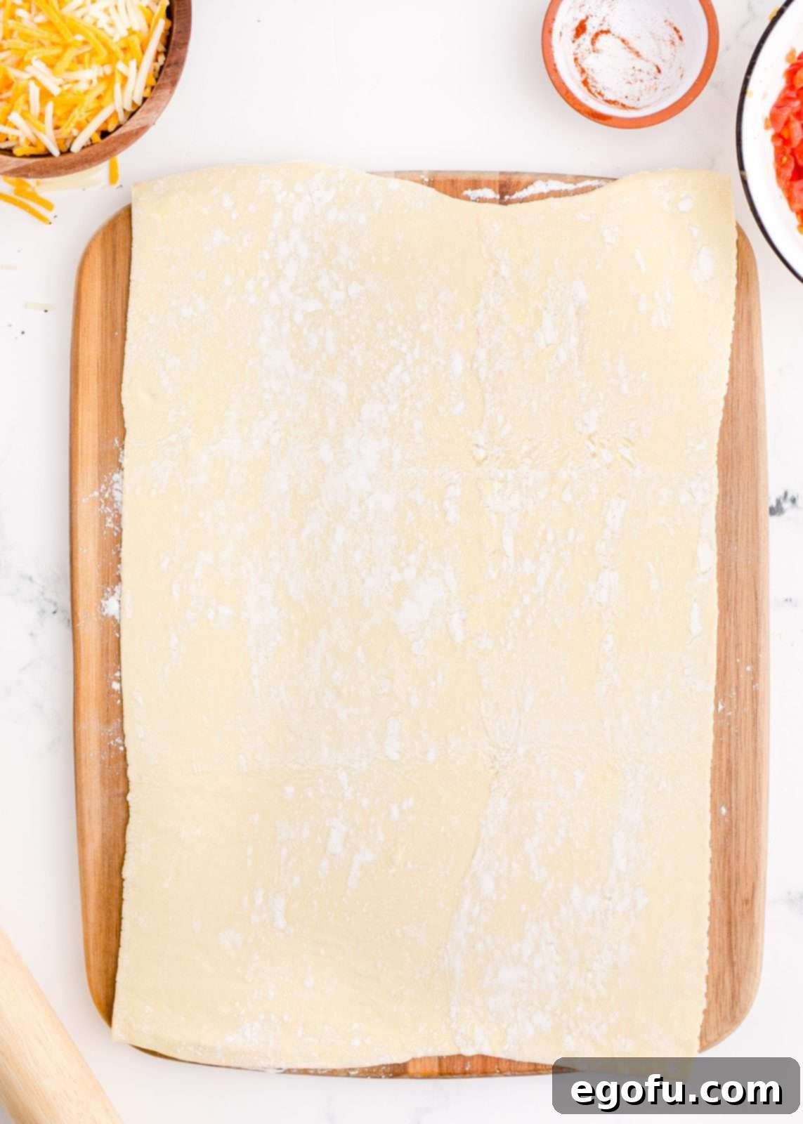 Zesty Taco Roll-Ups 8 A sheet of puff pastry, perfectly thawed and rolled out into a large rectangle on a flat, lightly floured surface, ready for filling.