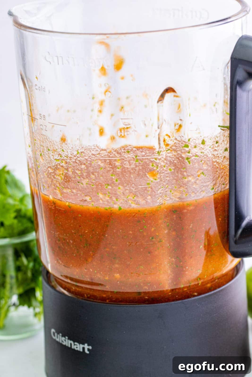 Effortless Blender Salsa 5 Homemade salsa expertly blended to a smooth consistency, visible inside a blender jar with the lid off.