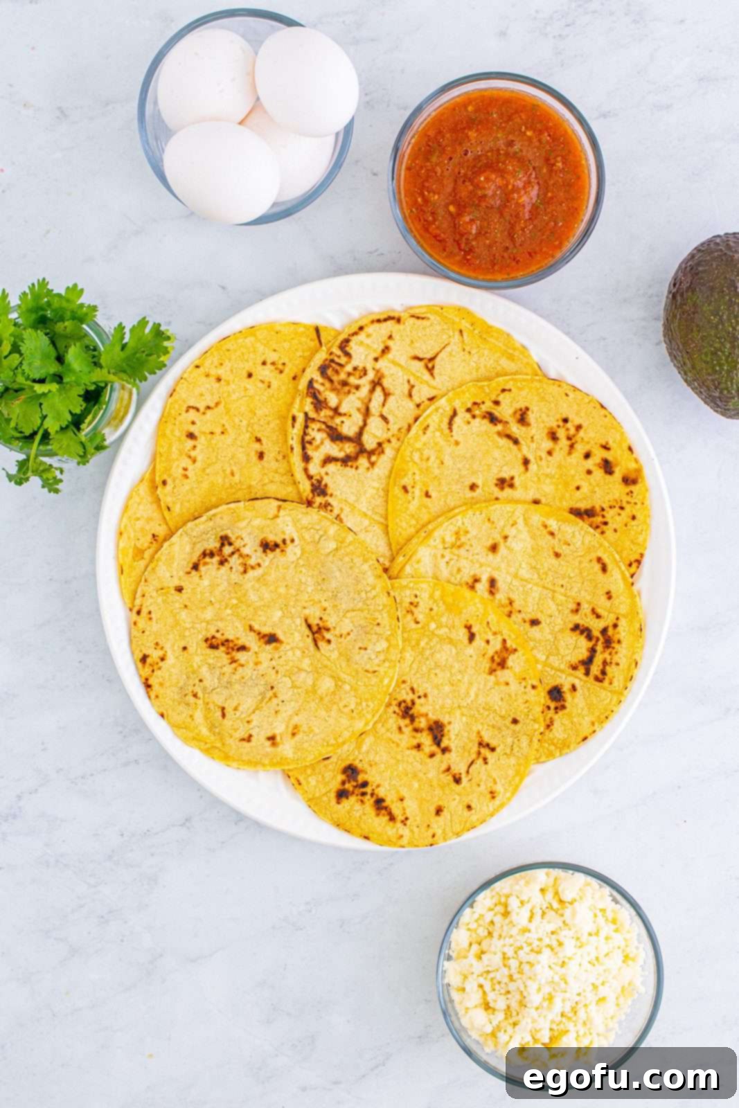 Zesty Ranch Morning Stack 4 Charred corn tortillas neatly stacked on a plate, ready for assembly.
