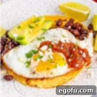 Zesty Ranch Morning Stack 7 Square image of finished and plated Huevos Rancheros, beautifully garnished.