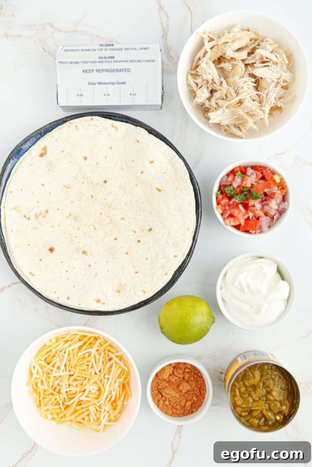 Ingredients needed: chicken, cream cheese, green chiles, taco seasoning, mexican cheese, tortillas and optional toppings.
