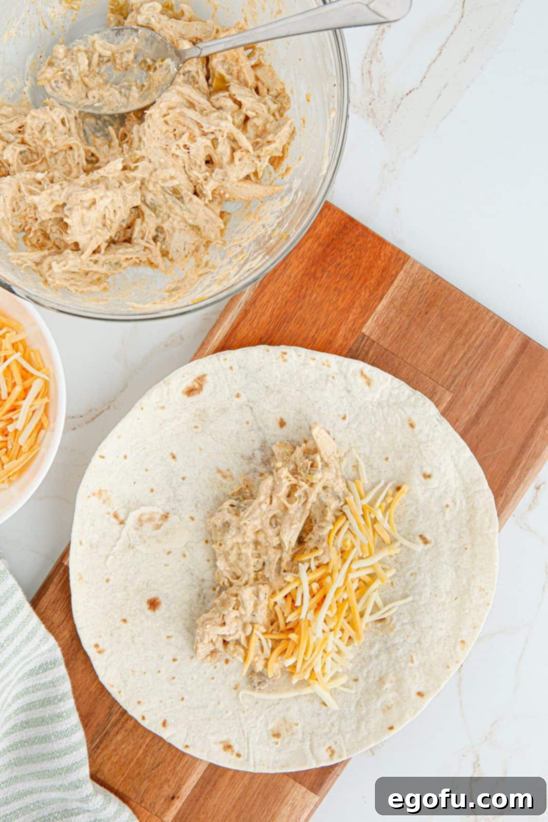 Chicken mixture and cheese on tortilla.