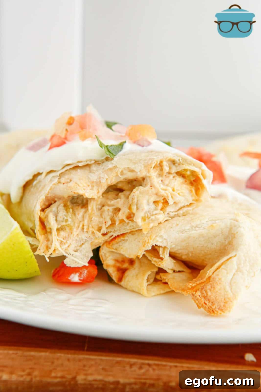 One split open Air Fryer Chicken Chimichanga on plate showing inside filling.