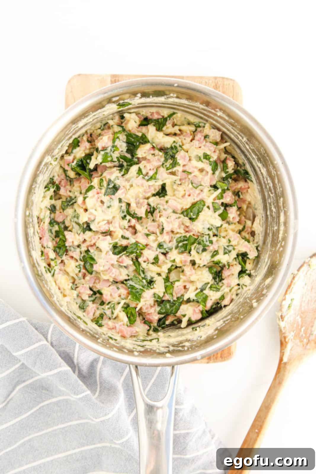 Sautéed onions, diced ham, and cheese stirred into the filling mixture with wilted spinach.