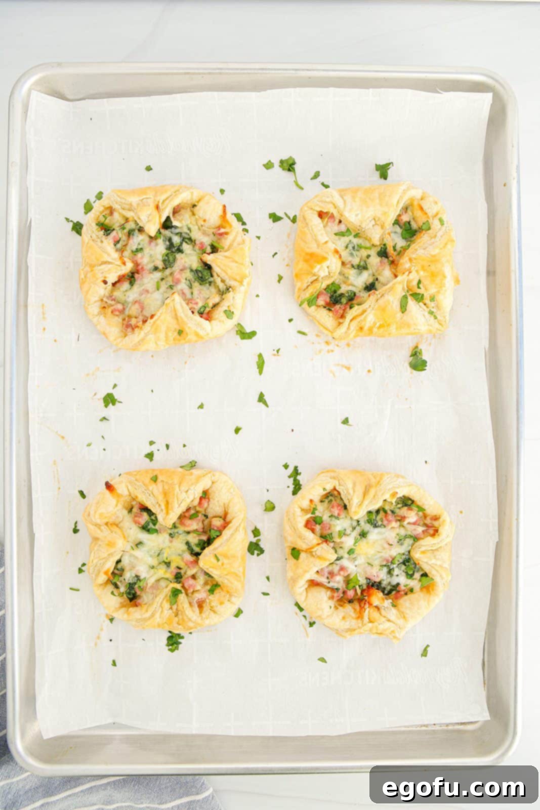 Finished Baked Ham and Cheese Squares fresh out of the oven on a baking sheet.