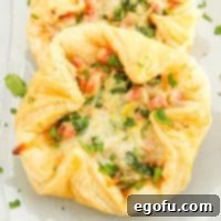 Close-up of a single Baked Ham and Cheese Square layered on others.