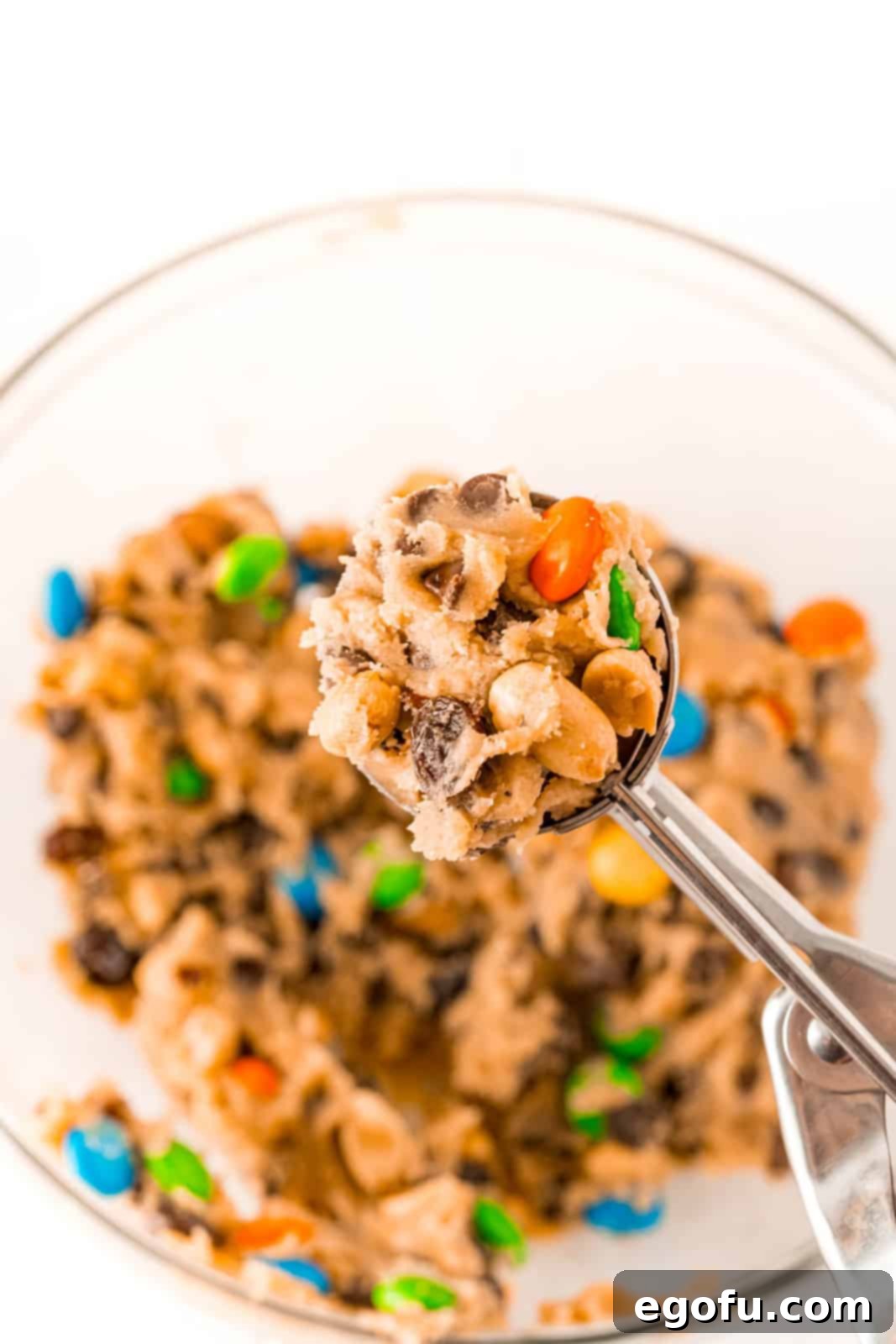 Cookie scoop holding full of cookie dough.