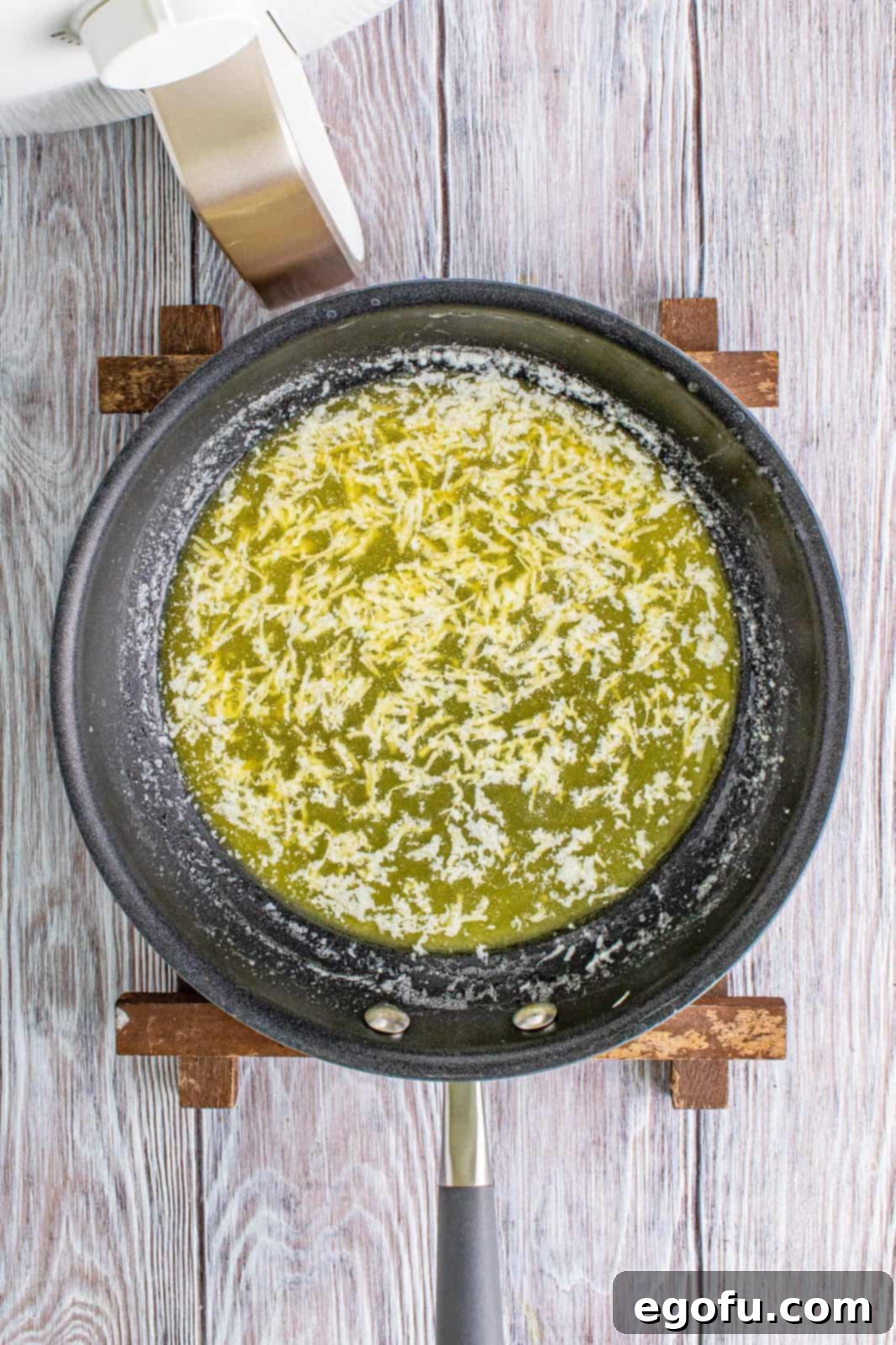 Unsalted butter melted in a small pan with fresh minced garlic gently cooking until fragrant.