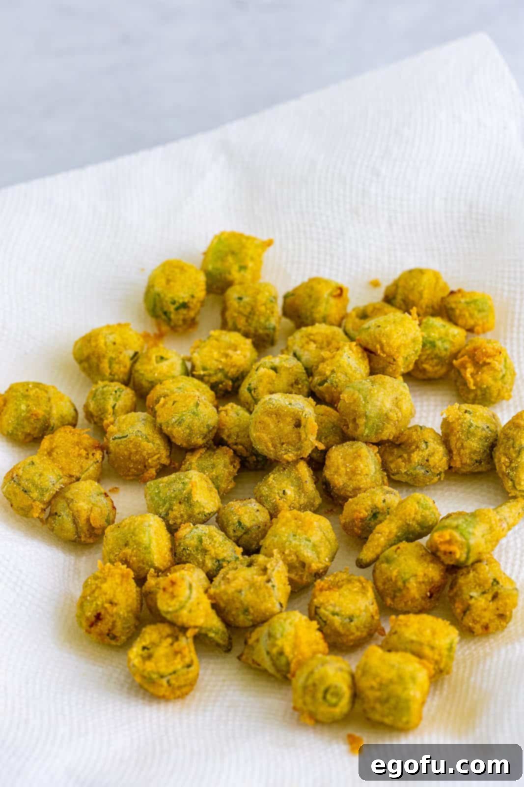 Soulful Crispy Okra 11 Fried okra draining on paper towel.