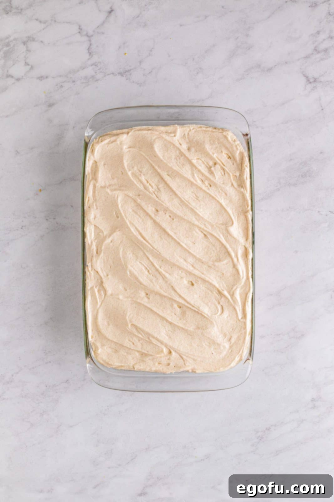 Southern Sunshine Cake 16 Frosting spread on top of cooled cake.