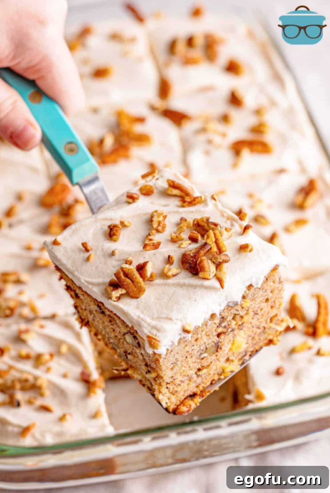 Southern Sunshine Cake 17 Spatula holding up one slice of Hummingbird Cake out of pan.