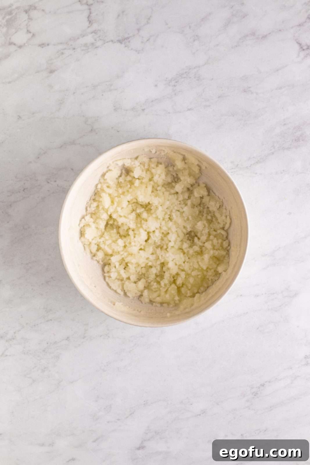 Southern Sunshine Cake 6 Sugar and oil whisked together in bowl.