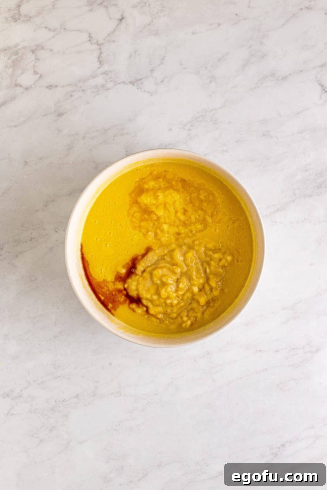 Southern Sunshine Cake 8 Mashed banana, pineapple, and vanilla added into the bowl with sugar and oil