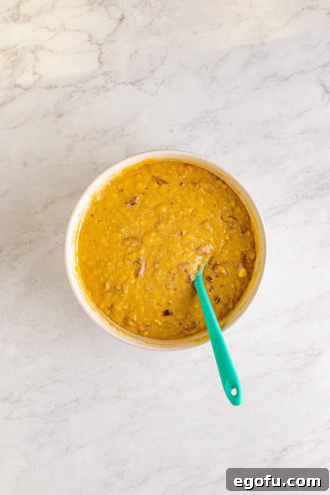 Southern Sunshine Cake 10 Chopped pecans folded into cake batter in bowl.