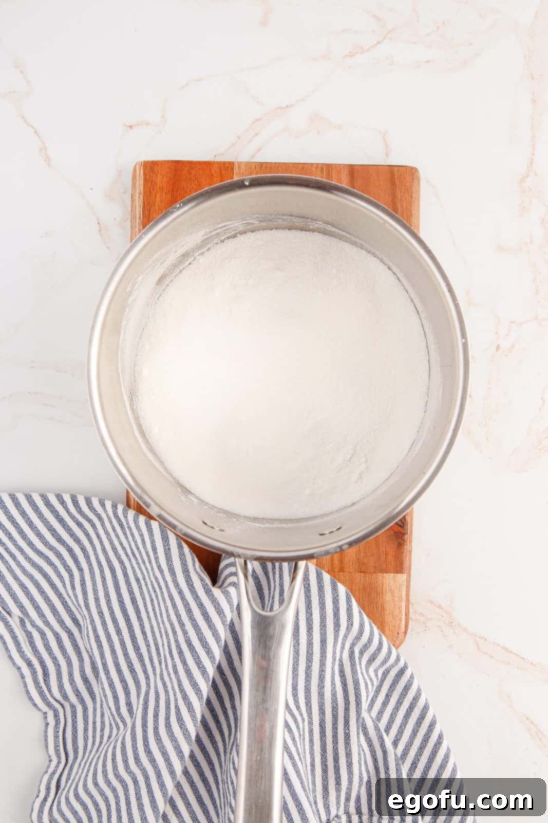 Sugar and cornstarch mixed together in pot.