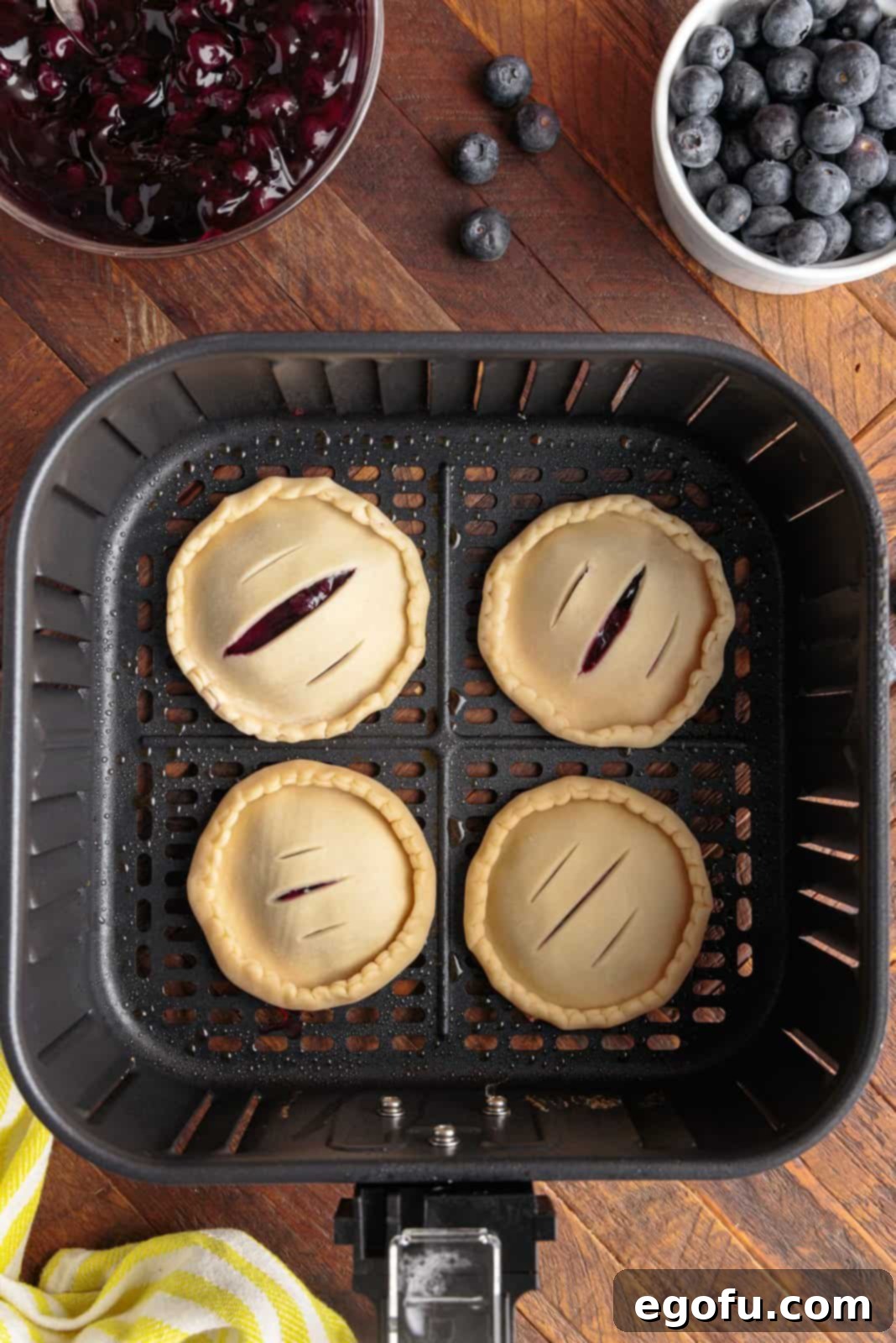 Hand pies placed into basket of air fryer.