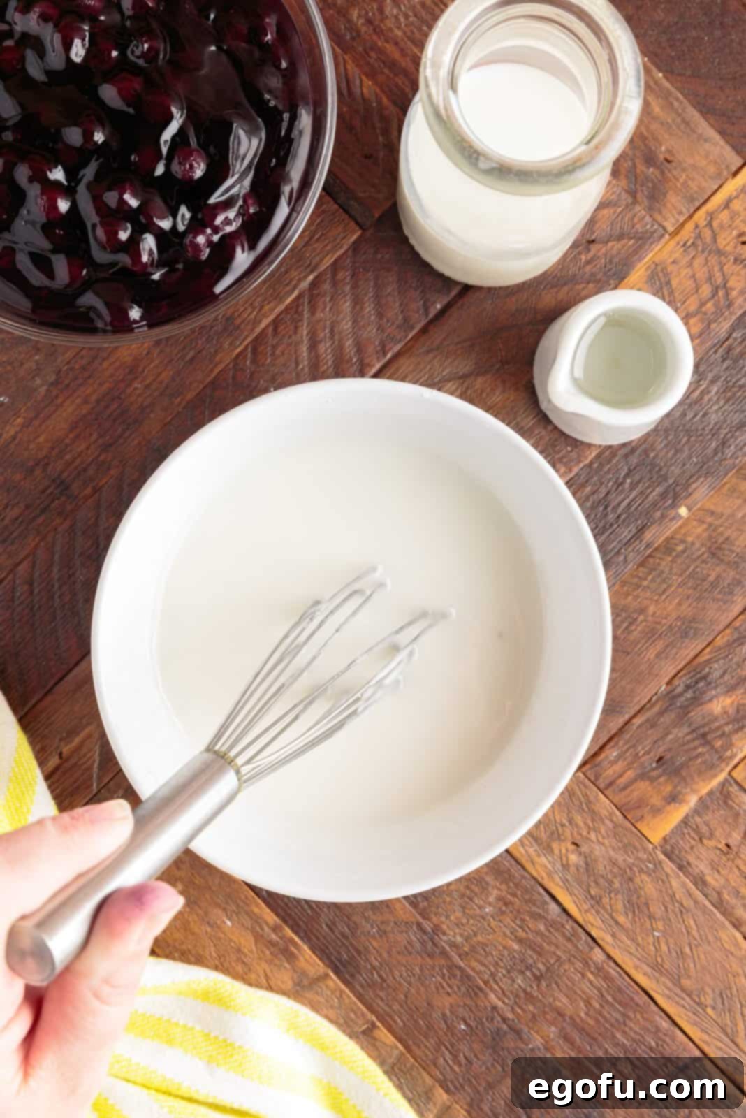 Glaze being mixed up in a bowl.