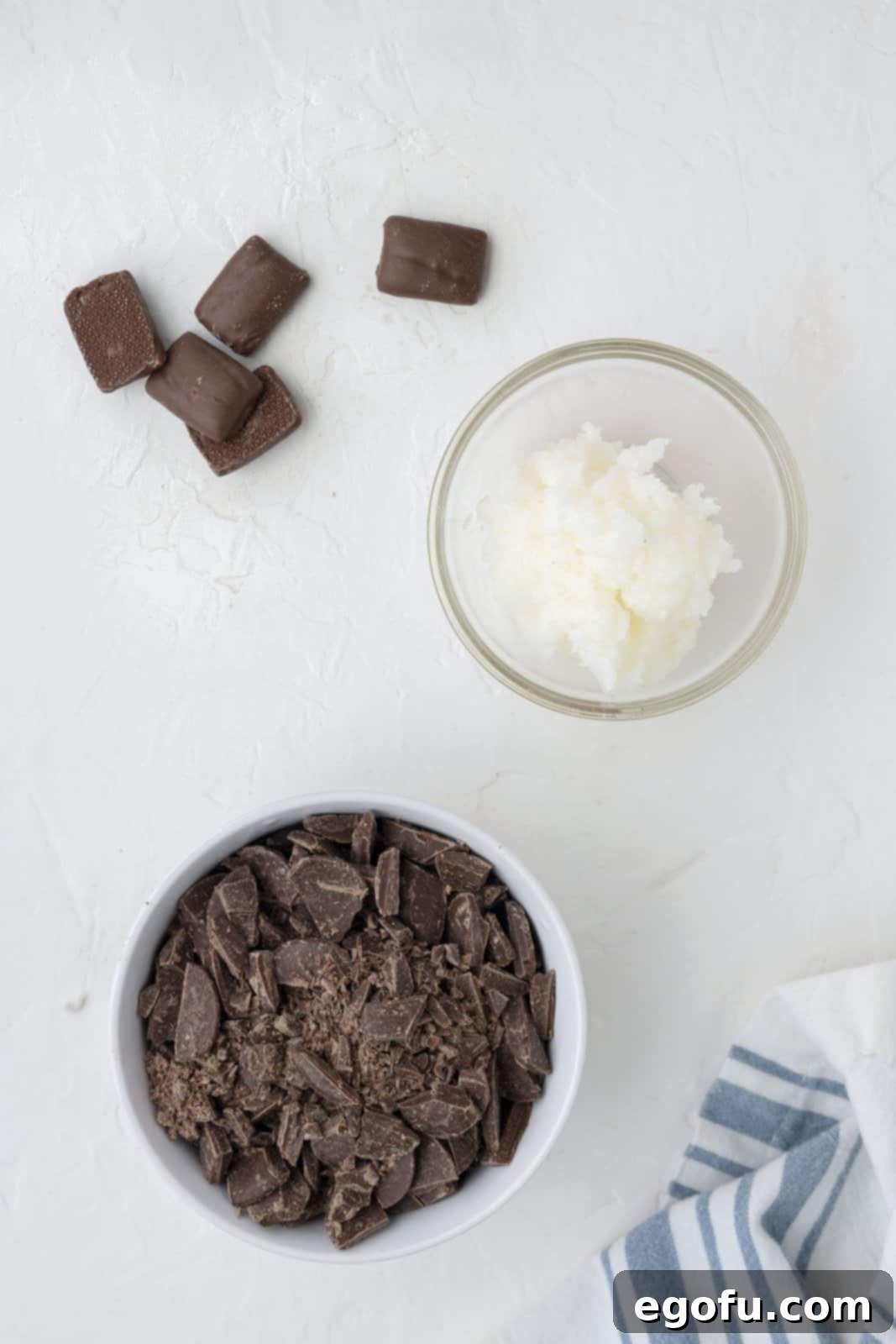 The three essential ingredients for Heath Bar Magic Shell: neatly chopped milk chocolate, solid coconut oil, and a finely crushed Heath bar, all laid out.
