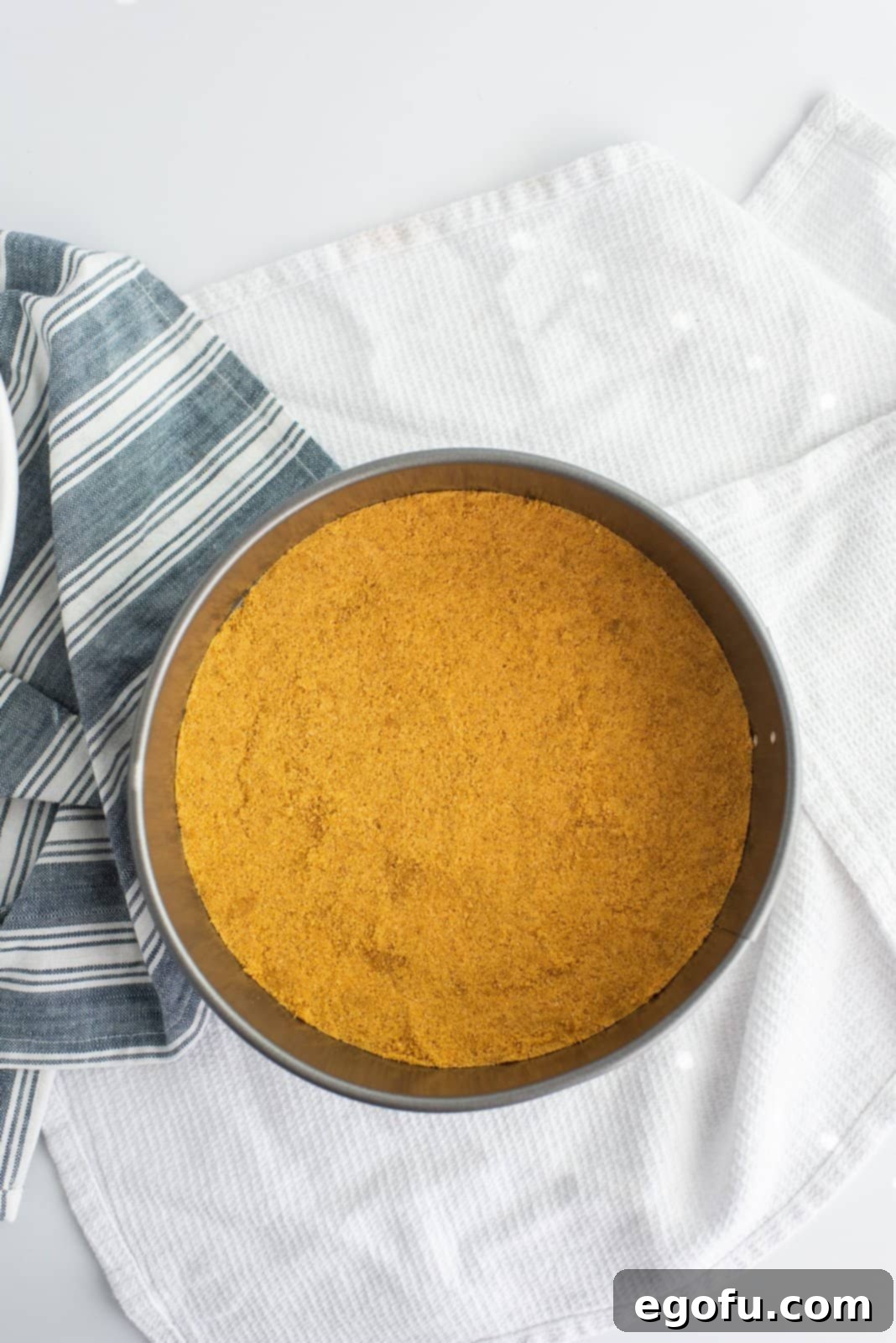 Crust mixture pressed into the bottom of a springform pan.