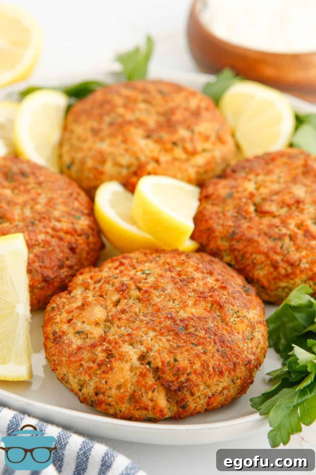 Crispy Air-Fried Salmon Cakes 2 Air Fryer Salmon Patties on plate with lemon slices.