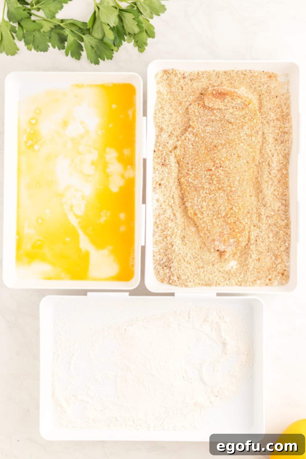 Chicken cutlet dredged in flour, eggs and breadcrumbs.