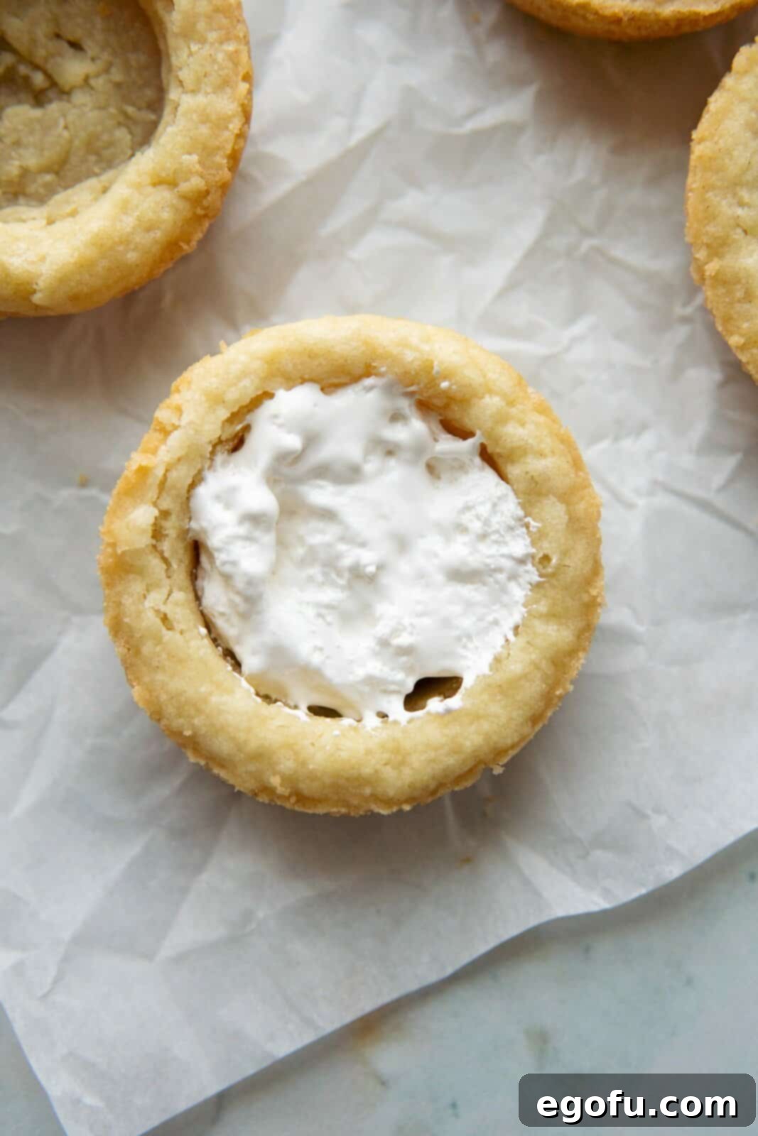Marshmallow creme added to one cookie cup.