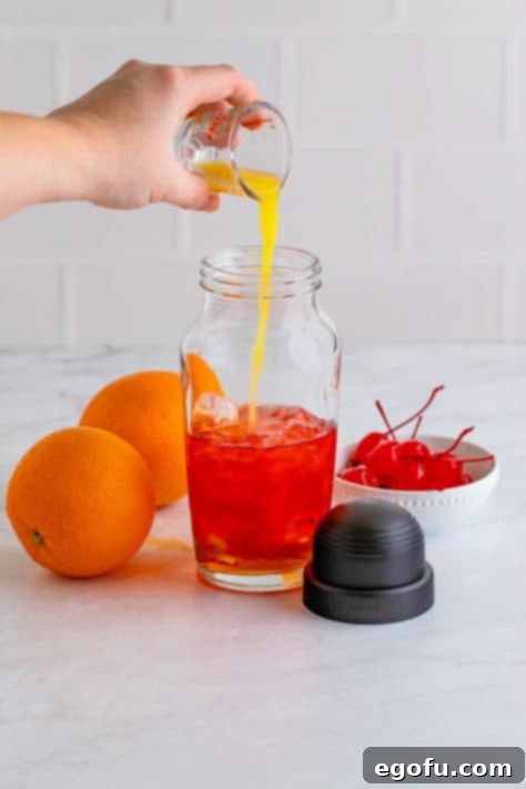 Dixie Dynamite 8 Alcohols being added to cocktail shaker.