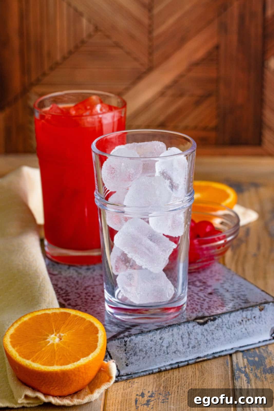 Dixie Dynamite 3 A glass filled with ice, ready for cocktail preparation.