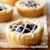 Berry Burst Cookie Cups 10 Close-up of Berry Cookie Cups with glaze on parchment paper.