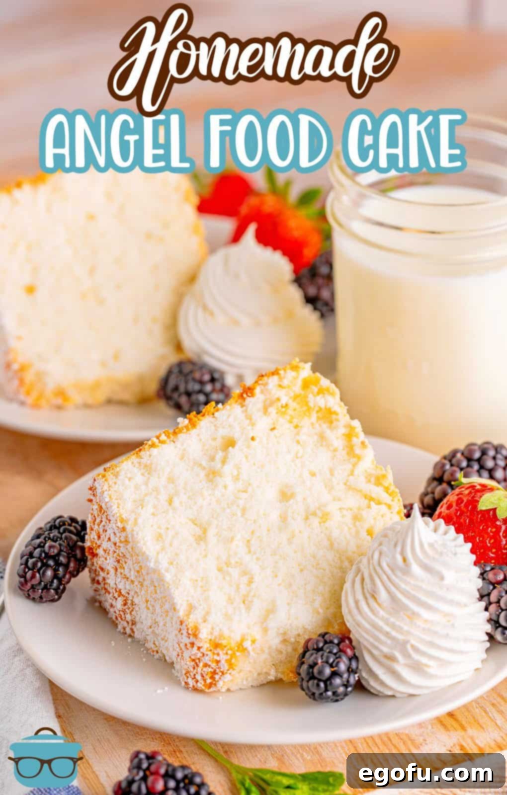 A large slice of homemade Angel Food Cake on a plate with fresh berries.